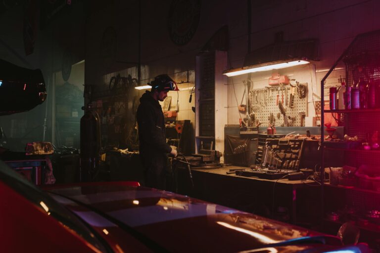 Man in Black Jacket Standing Near Table
