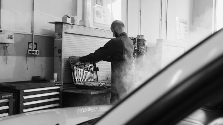 Man in Black Overall Choosing a Wrench